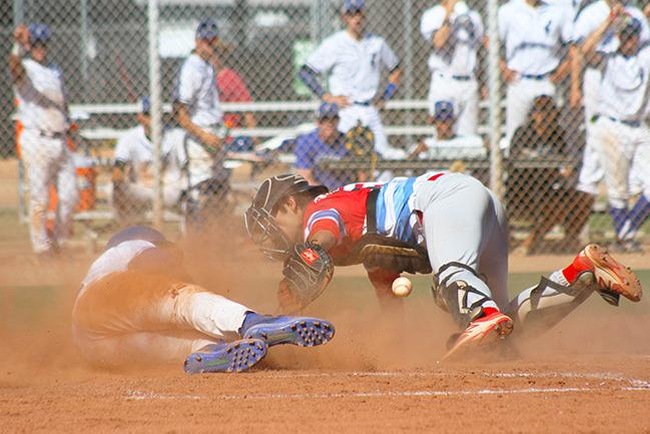 Mesa catcher Marcus Skundrich gets the ball knocked loose by a Gateway base runner Tuesday afternoon. (photo by Aaron Webster)