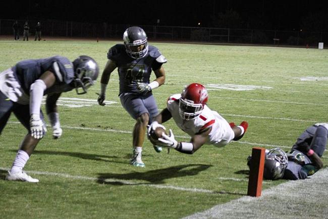 Mesa's Sonnie Richardson (#1) dives into the endzone for the deciding touchdown against the Scottsdale Artichokes Saturday night.