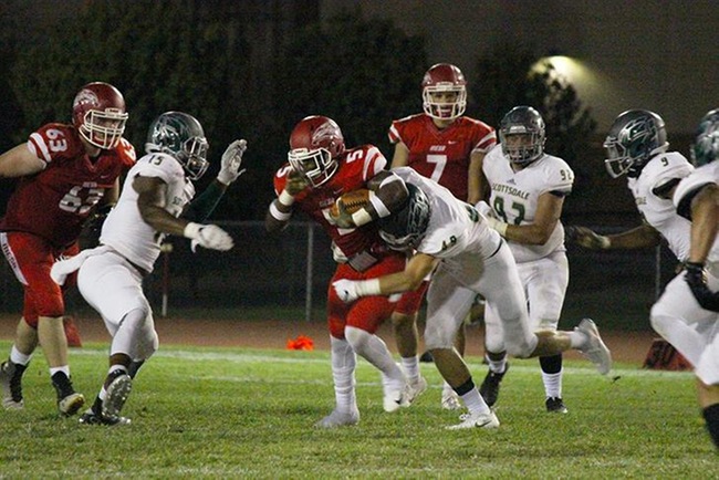 Mesa's Terrance Roberts Jr. gets wrapped up by a couple Scottsdale defenders in Saturday nights game. (Photo by Aaron Webster)