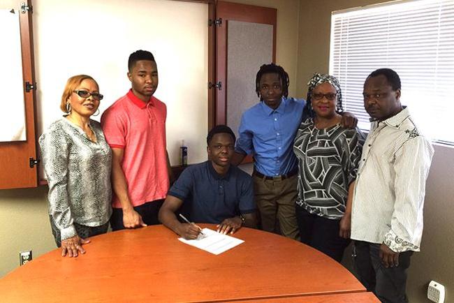 Obi Megwa, surrounded by his family, signs with MCC