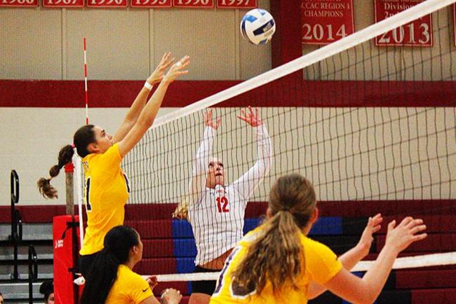 Mesa's Casey Reid(#12) sets during the home match against Eastern Arizona(photo by Jacob Dewald)
