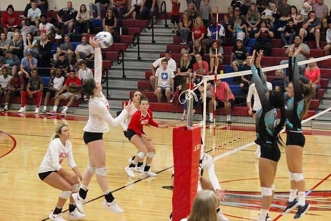 Mesa's Becca Belles goes high for the kill Wednesday night against the Chandler-Gilbert Coyotes.  (Photo by Aaron Webster)