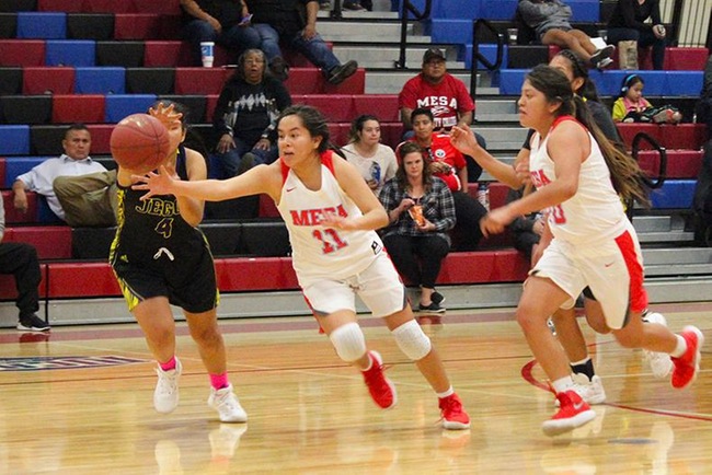 Lynnae Mitchell (#11) attacks a Jego loose ball in Wednesday night's win over Tohono O'Odham.