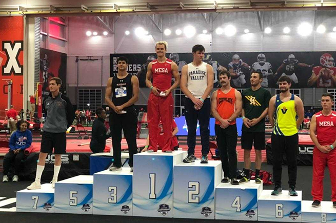 Kyle Downey on the winners's stand after capturing indoor pole vault title